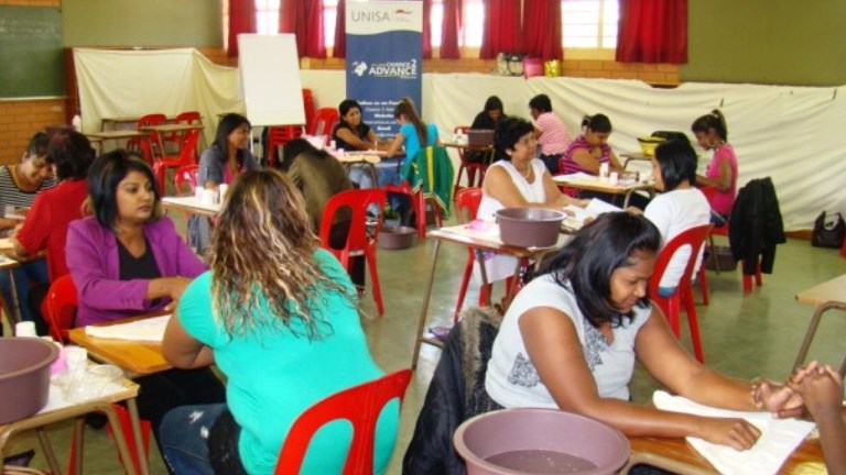 Participants in the Introduction to Manicure & Pedicure workshop engaging in practical’s with each other